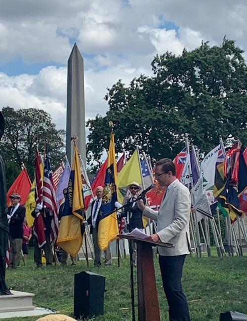 Michael Crowder standing at a lectern in Green-Wood Cemetery